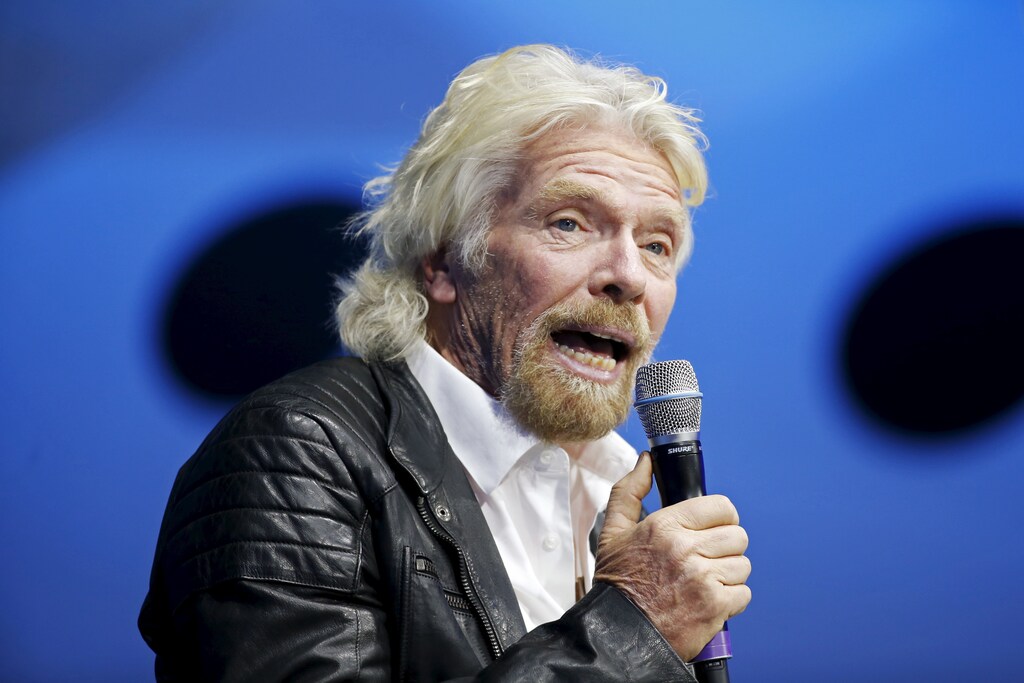 Richard Branson unveils the new SpaceShipTwo, a six-passenger two-pilot vehicle meant to ferry people into space that replaces a rocket destroyed during a test flight in October 2014, in Mojave, California, United States, February 19, 2016. REUTERS/Lucy Nicholson - RTX27RO1