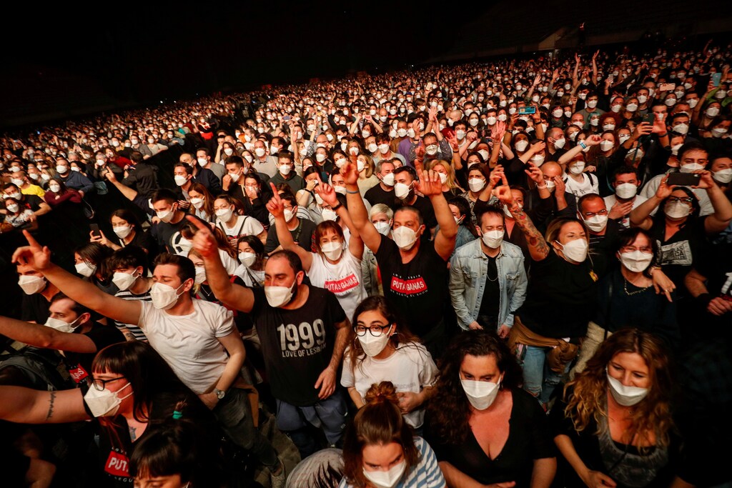 People wearing protective masks attend a concert of "Love of Lesbian" at the Palau Sant Jordi, the first massive concert since the beginning of the coronavirus disease (COVID-19) pandemic in Barcelona, Spain, March 27, 2021.