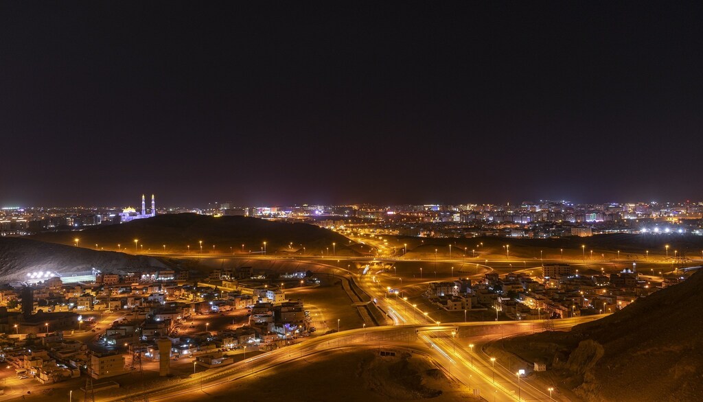 A landscape shot of roads outside a city in Oman at night