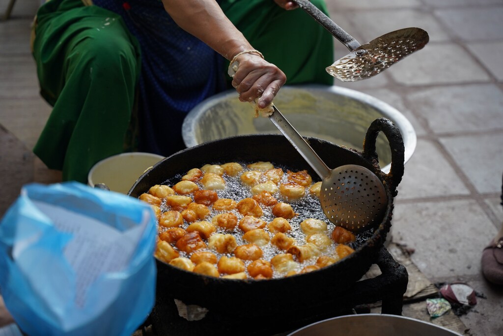 A man fries food with cooking oil.