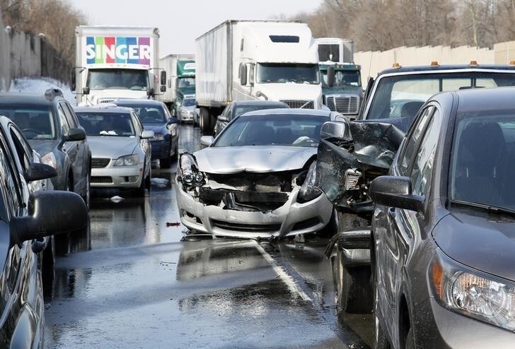 Smashed vehicles await assistance as dozens of flipped-over cars, jack-knifed tractor-trailers and vehicles skidded off the Pennsylvania Turnpike during the morning commute, shutting down the major thoroughfare near the Bensalem interchange in Pennsylvania, February 14, 2014. The U.S. East Coast dug out on Friday from the final wallop of a deadly four-day storm that dumped more than two feet of snow in some places and made a mess of the morning commute, triggering crashes of up to 100 vehicles in Pennsylvania. REUTERS/Tom Mihalek (UNITED STATES - Tags: TRANSPORT DISASTER ENVIRONMENT)