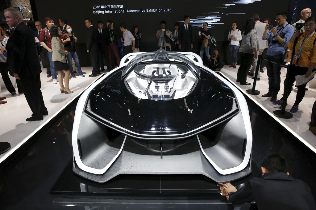 Visitors gather around the Faraday Future FFZERO1 electric concept car during the Auto China 2016 auto show in Beijing April 25, 2016. REUTERS/Damir Sagolj - RTX2BHE5