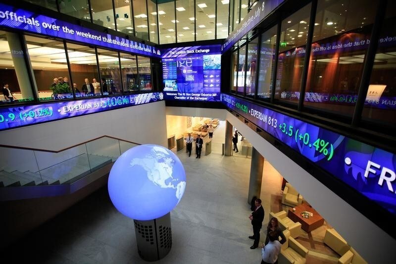 Financial data and news headlines stream accross ticker screens around the atrium of the London Stock Exchange after Britain's Chancellor of the Exchequer George Osborne inaugurated the ceremonial market opening in the City of London, May 10, 2011. REUTERS/Andrew Winning (BRITAIN - Tags: POLITICS BUSINESS) - RTR2M7G0