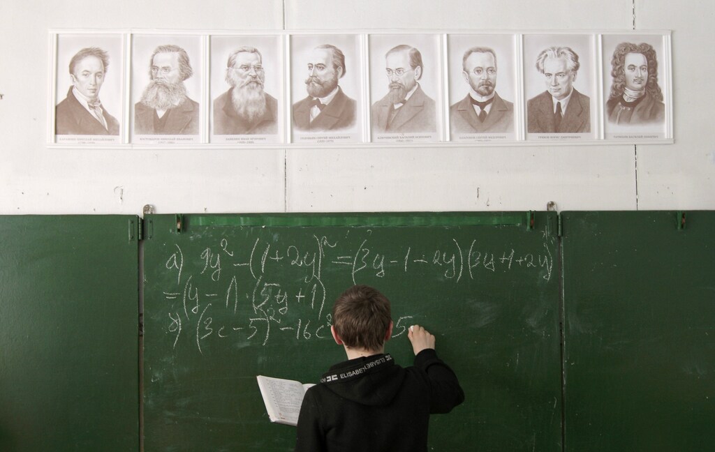 Andrey Marchenkov, 13 writes on the blackboard as he attends a mathematics lesson at a local school based in the remote Russian village of Bolshie Khutora, about 440 km (273 miles) west of Moscow, March 14, 2012. The school, well-known in the region for only 12 pupils studying here, is situated in the village, population of which decreases each year. Nevertheless the school authorities and teachers are proud of the high level of education given to the few students who are treated individually and carefully here. Pupils, many of whom are winners of numerous local educational contests, like studying and exploring ecology, according to school representatives. REUTERS/Vasily Fedosenko (RUSSIA - Tags: EDUCATION TPX IMAGES OF THE DAY) - GM1E83E1TPZ01