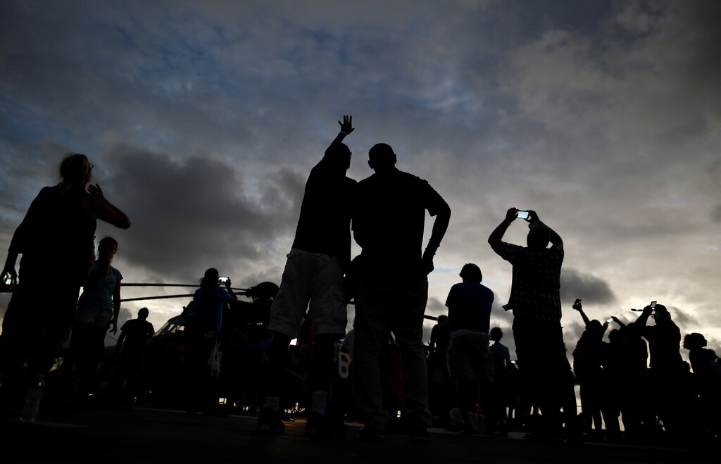 People watch from the flight deck of the Naval museum ship U.S.S. Yorktown during the Great American Eclipse in Mount Pleasant, South Carolina, U.S. August 21, 2017. Location coordinates for this image are 32°47'26" N 79°54'31" W. REUTERS/Randall Hill - RC16897D8BB0