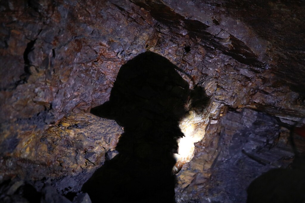 The shadow of a man who works as a miner is cast onto a rock as he enters a gold mine in La Riconada, the Andes, Peru, October 9, 2019. REUTERS/Nacho Doce SEARCH "WOMEN GOLD PICKERS FEMICIDE" FOR THIS STORY. SEARCH "WIDER IMAGE" FOR ALL STORIES - RC2AEF9H5FBF