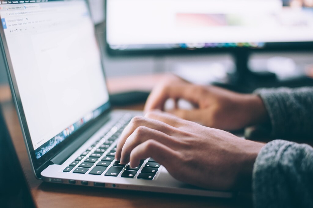 Online learning: Someone typing in a laptop keyboard.
