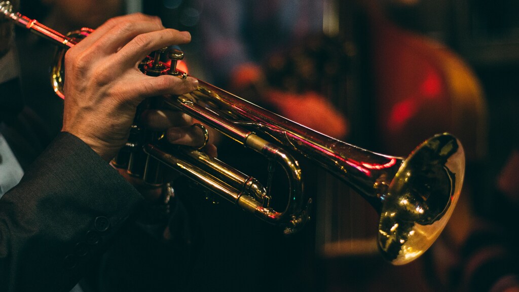 this is someone playing jazz on a trumpet. Jazz music is something that would be challenging for artificial intelligence to replicate, due to its often spontaneous nature