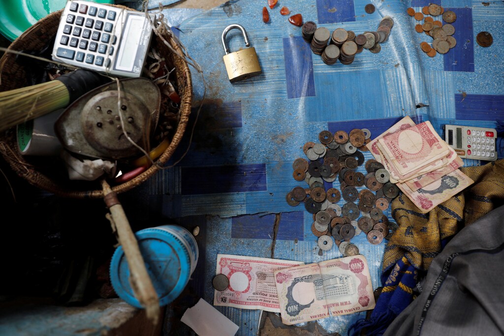 Old Nigerian currency is seen on a carpet in a local exchange shop in the old district of Nigeria's northern city of Kano, August 24, 2017.