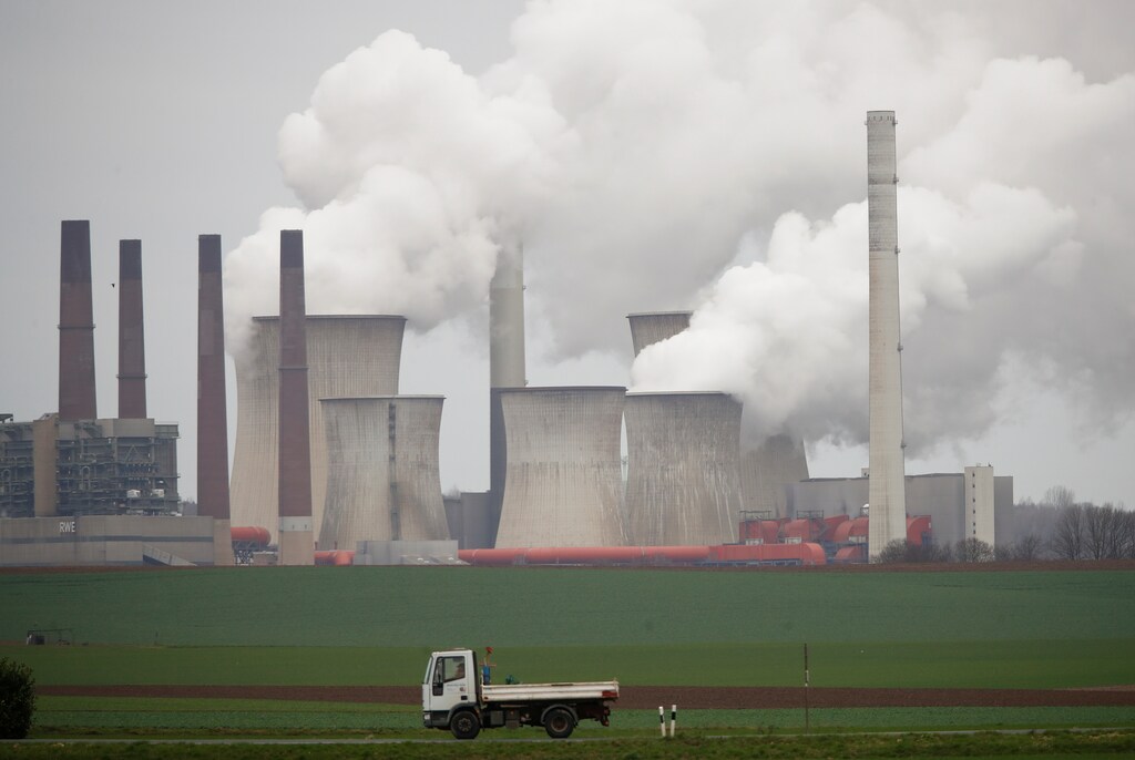 A truck drives by as steam rises from the five brown coal-fired power units of RWE, one of Europe's biggest electricity companies in Neurath, north-west of Cologne, Germany, Germany, March 12, 2019. REUTERS/Wolfgang Rattay - RC1795859580