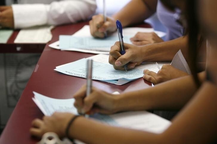Applicants fill out forms during a job fair at the Southeast LA-Crenshaw WorkSource Center in Los Angeles November 20, 2009. In a depressed neighborhood in the City of Angels, hundreds of good jobs appeared to fall from the sky last week. Young and middle-aged Los Angeles residents, mostly blacks and Hispanics, lined up down the block at an employment office for more than 600 jobs, paying $14 an hour and higher with free healthcare, at new JW Marriott and Ritz Carlton hotels downtown. Picture taken November 20, 2009. REUTERS/Mario Anzuoni (UNITED STATES EMPLOYMENT BUSINESS)