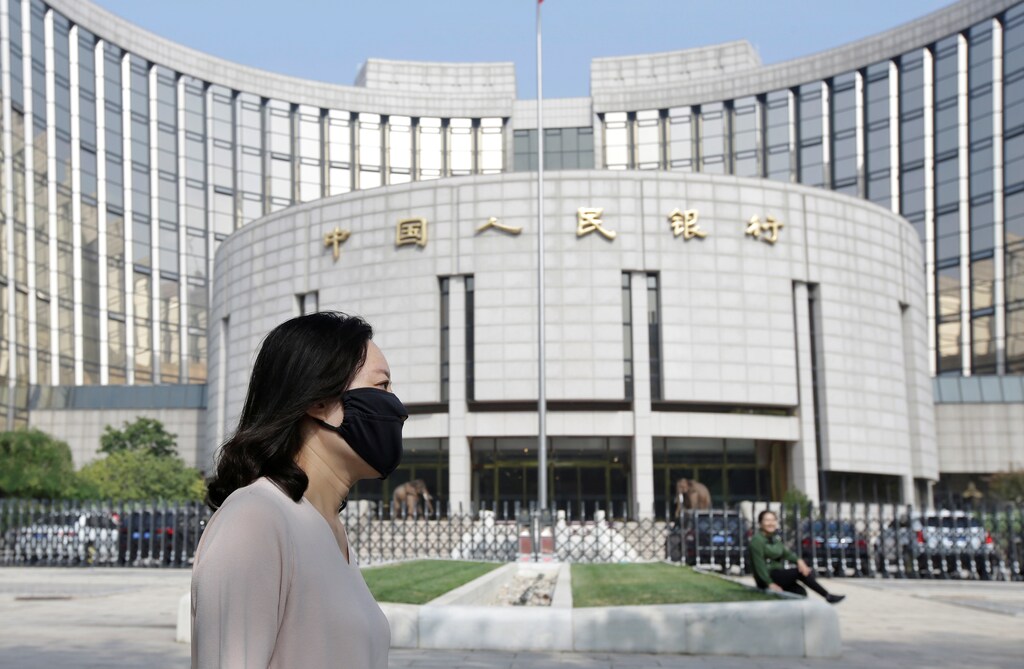 A woman walks past the headquarters of the People's Bank of China (PBOC), the central bank, in Beijing, China September 28, 2018
