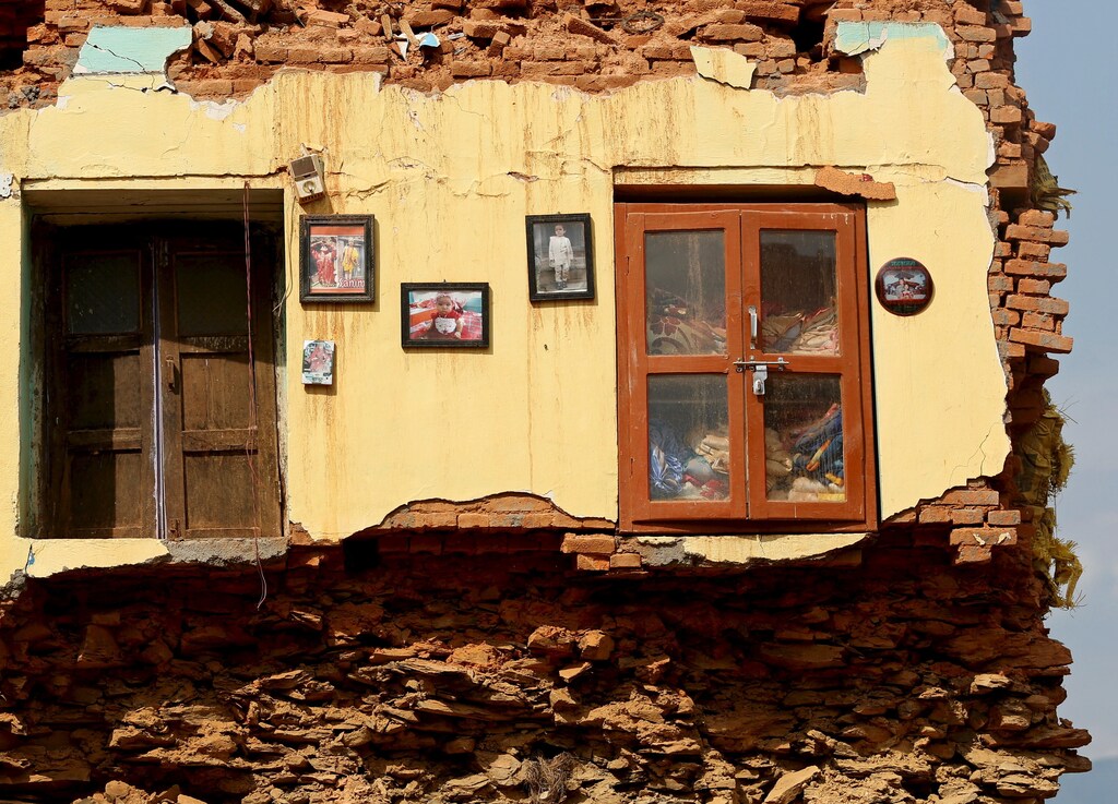 Framed pictures are seen hanging from the wall of a house damaged by earthquakes in Sindhupalchowk district, Nepal, May 13, 2015. REUTERS/Ahmad Masood TPX IMAGES OF THE DAY - GF10000093335