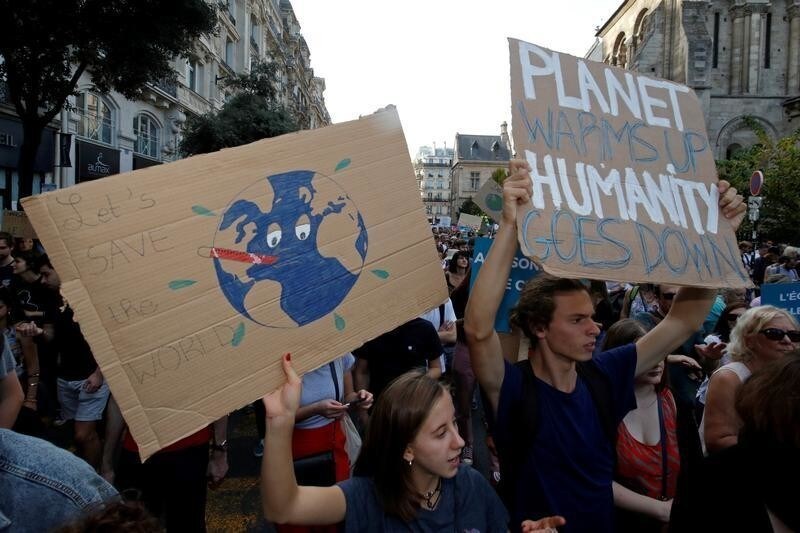 Protesters march to urge politicians to act against climate change in Paris, France, October 13, 2018.