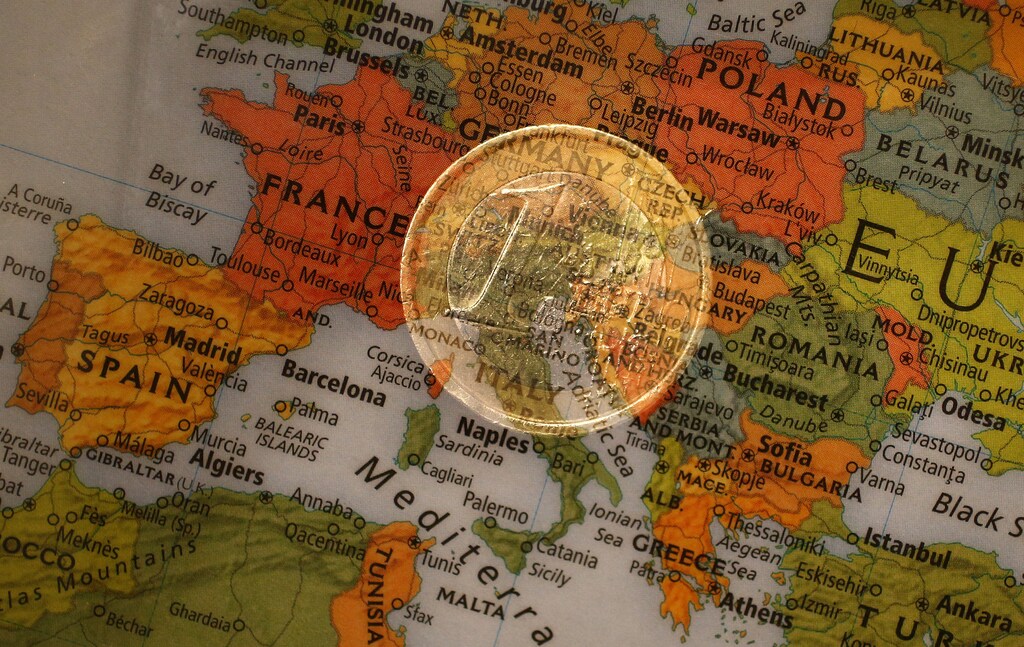 A picture illustration taken with the multiple exposure function of the camera shows a one Euro coin and a map of Europe, January 9, 2013. The cost of living in the euro zone rose more than expected in December but remained benign enough to allow a possible cut in interest rates in 2013 to support the bloc's feeble economy. The European Central Bank's Governing Council meets on Jan. 10, with policymakers appearing unwilling to countenance a rate cut so early in the year. REUTERS/Kai Pfaffenbach (GERMANY - Tags: BUSINESS POLITICS) - RTR3C92N