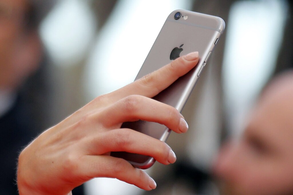 A guest uses her Iphone to take pictures on the red carpet as she arrives for the screening of the film "Money Monster" out of competition at the 69th Cannes Film Festival in Cannes, France, May 12, 2016.