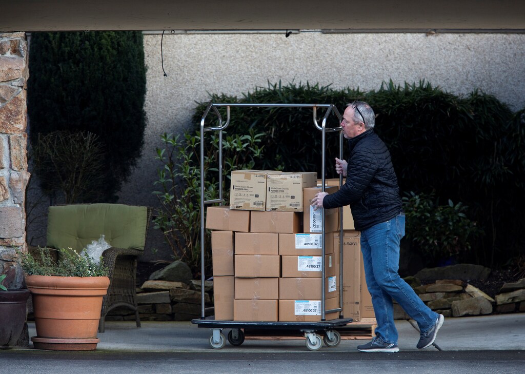 A staff member moves medical supplies delivered by a State of Washington Department of Corrections truck at the Life Care Center of Kirkland, a long-term care facility linked to several confirmed coronavirus cases, in Kirkland, Washington, U.S. March 8, 2020. REUTERS/Lindsey Wasson - RC2YFF9OR3W9