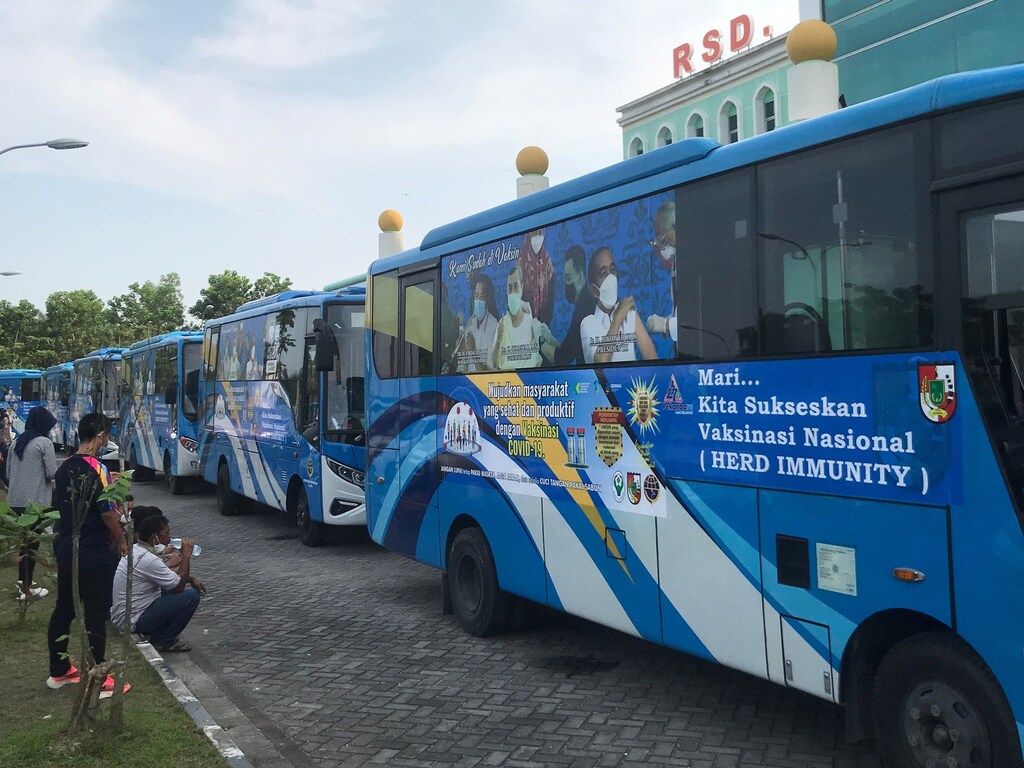 Public buses, used as a coronavirus disease (COVID-19) vaccination venue, are seen parked outside the Madani hospital in Pekanbaru, Riau province, Indonesia, June 8, 2021. Picture taken June 8, 2021. REUTERS/Stringer - RC21WN9VOOA3
