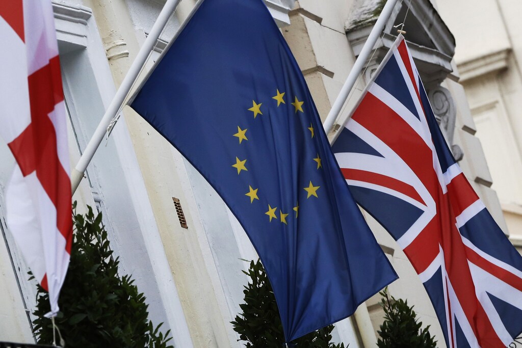 The St George's Cross, European Union and Union flags fly outside a hotel in London, Britain, December 17, 2015. European Union leaders could clinch a deal with British Prime Minister David Cameron in February to prevent the bloc's second largest economy leaving, European Council President Donald Tusk said on Thursday. Cameron is seeking to renegotiate Britain's relationship with the bloc it joined in 1973 ahead of a referendum on membership to be held by the end of 2017. Some EU leaders are wary of agreeing to all of his demands, however, particularly on cutting benefits for EU migrants to Britain.