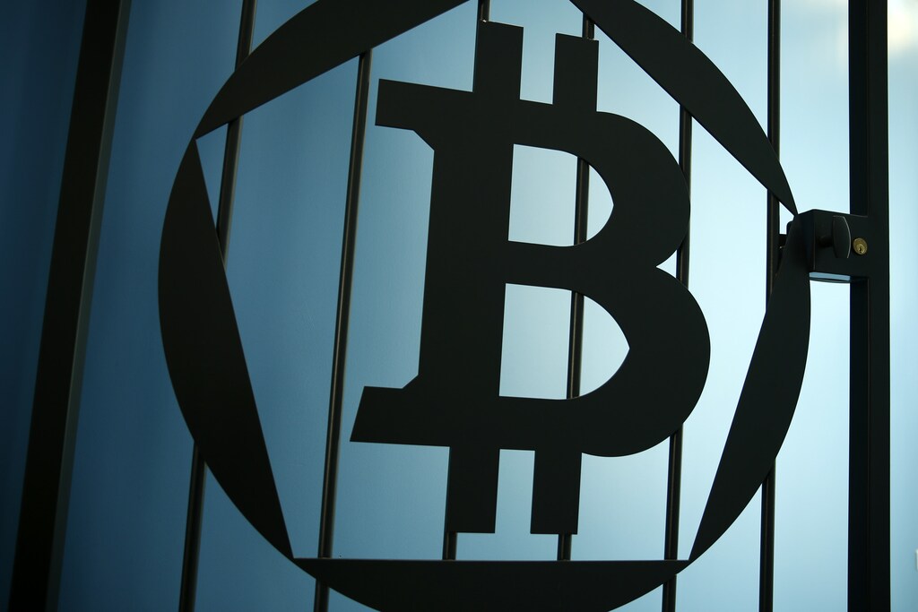 A Bitcoin (virtual currency) logo is pictured on a door in an illustration picture taken at La Maison du Bitcoin in Paris May 27, 2015. British authorities have come out in support of digital currencies in the name of promoting financial innovation, while proposing that regulations should be drawn up to prevent their use in crime. But it is technophiles who are leading the drive to make London a real-world hub for trade in web-based "cryptocurrencies", of which bitcoin is the original and still most popular. Picture taken May 27, 2015. REUTERS/Benoit Tessier - RTX1EWRL