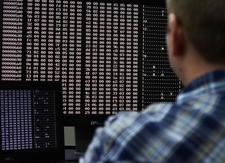 An analyst looks at code in the malware lab of a cyber security defense lab at the Idaho National Laboratory in Idaho Falls, Idaho September 29, 2011. REUTERS/Jim Urquhart (UNITED STATES - Tags: BUSINESS LOGO CRIME LAW MILITARY POLITICS SCIENCE TECHNOLOGY)