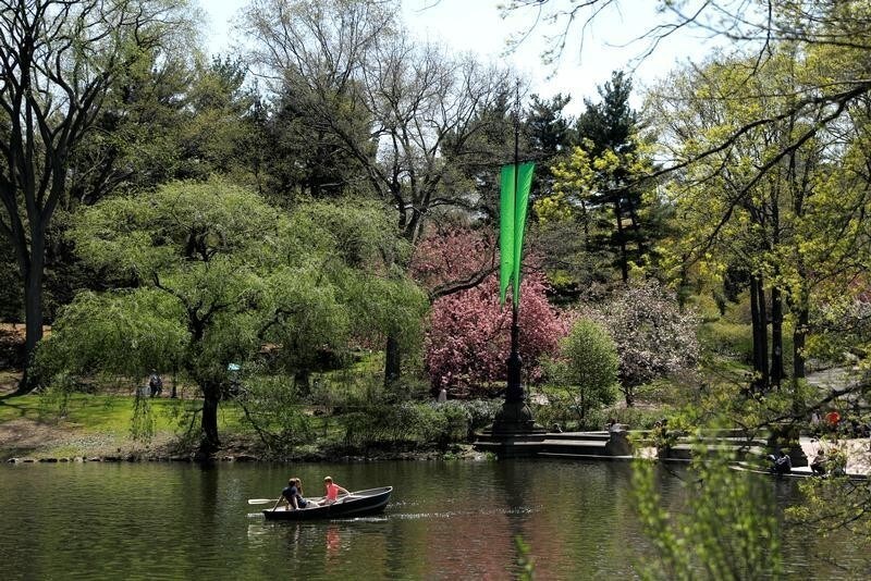 People relax in a rowboat on a warm spring day on The Lake near the Bethesda Fountain in Central Park in New York City, New York, U.S., May 2, 2018.
