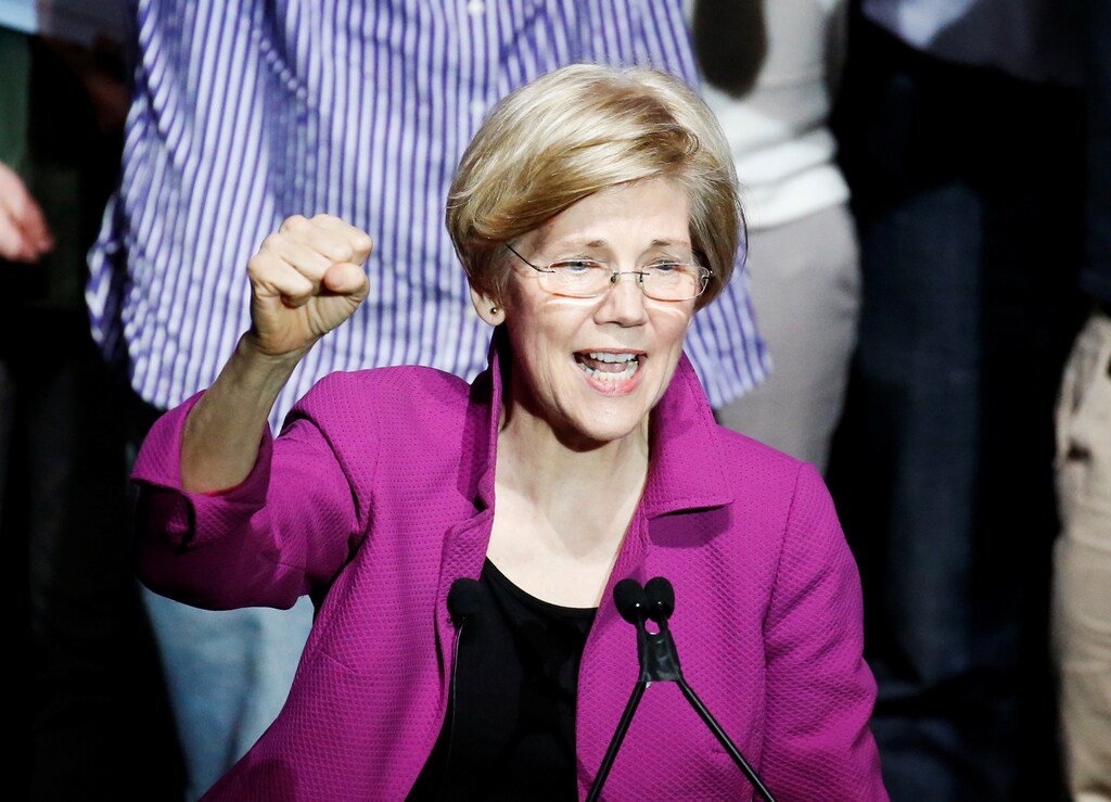 U.S. Senator Elizabeth Warren pumps her fist as she speaks at a Our Revolution rally in Boston, Massachusetts, U.S. March 31, 2017. REUTERS/Mary Schwalm - RTX33LDE
