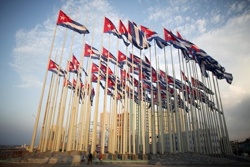 Tourists take pictures of Cuban flags in front of the U.S embassy in Havana, July 27, 2015. U.S. Secretary of State John Kerry will travel to Cuba on August 14 to formally re-designate the U.S. Interests Section as the U.S. Embassy in Havana.