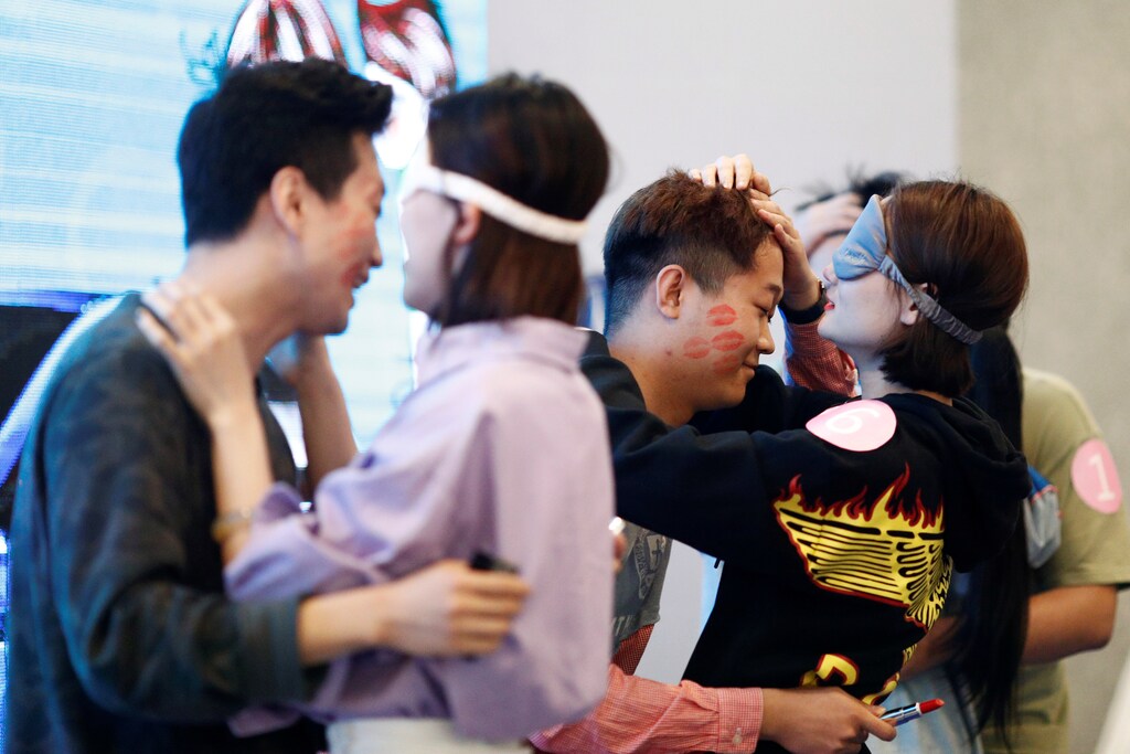 Couples take part in a kissing competition held inside a shopping mall in Taiyuan, Shanxi province, China May 20, 2018, to mark the date 520, which is phonetically similar to "I love you" in Chinese. Picture taken May 20, 2018. REUTERS/Stringer ATTENTION EDITORS - THIS IMAGE WAS PROVIDED BY A THIRD PARTY. CHINA OUT. - RC1631802F20