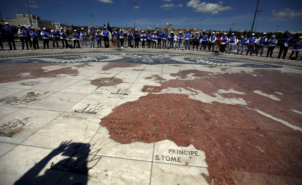A group of volunteers gather on a square decorated with a giant world map, during Earth Day celebrations in Lisbon April 22, 2015. Volunteers held placards with letters forming the sentence "We take care of the Earth". Earth Day, which promotes awareness and protection of the environment, is celebrated annually on April 22. REUTERS/Rafael Marchante - RTX19TNW