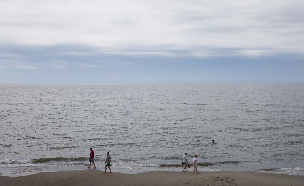 People gather at the shore of Baltic Sea at Curonian Spit north of the Baltic Sea port of Kaliningrad, Russia, July 18, 2015. Kaliningrad is one of the Russian cities, which will host the 2018 World Cup.