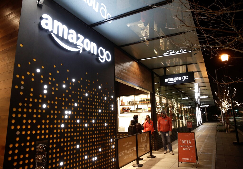 Amazon employees are pictured outside the Amazon Go brick-and-mortar grocery store without lines or checkout counters, in Seattle Washington, U.S. December 5, 2016. REUTERS/Jason Redmond - RTSUU2B
