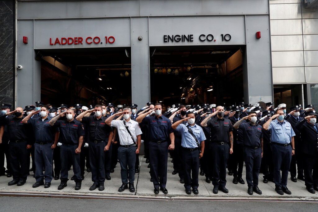 New York City Fire Department (FDNY) firefighters salute outside Ladder Co. 10, Engine Co. 10 on the 19th anniversary of the September 11, 2001 attacks on the World Trade Center in the Manhattan borough of New York City, New York, U.S., September 11, 2020. REUTERS/Shannon Stapleton - RC2CWI9L2HI7
