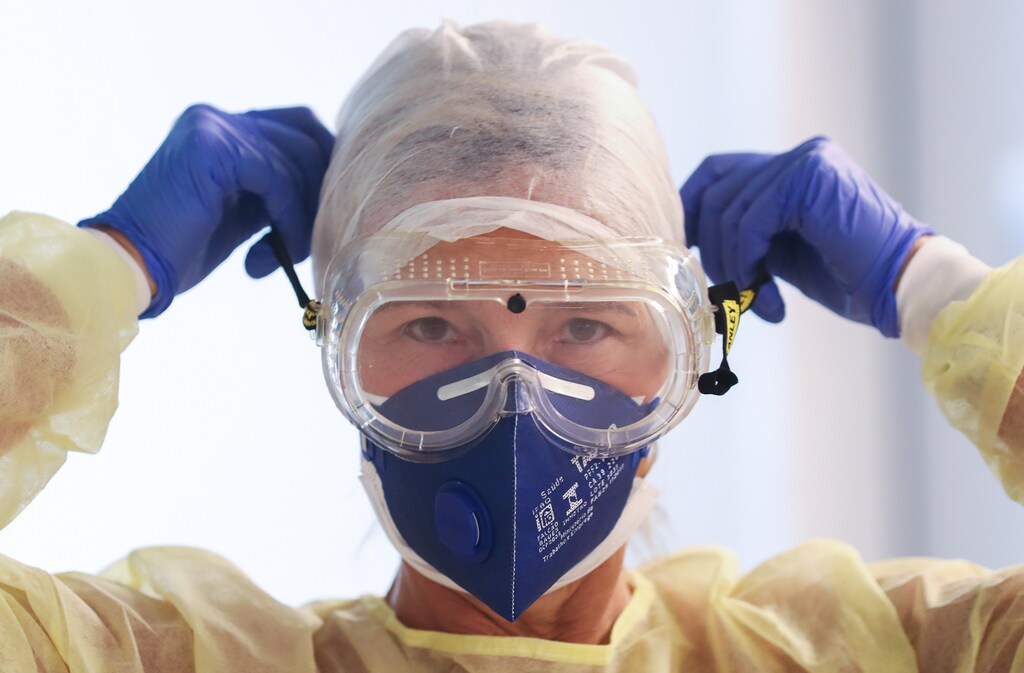 A member of the medical personnel works as patients suffering from coronavirus disease (COVID-19) are treated at CHIREC Delta Hospital in Brussels, Belgium, April 18, 2020. Disruption in essential health services during the pandemic resulted in a drop in immunisation coverage for the first time in a decade