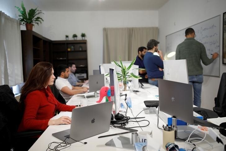 Employees of the D-ID startup company work at the company's office in Tel Aviv, Israel February 7, 2018. Picture taken February 7, 2018. REUTERS/Amir Cohen