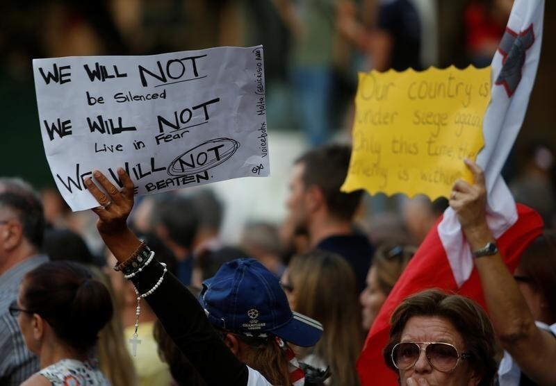 People take part in a protest over the assassination of investigative journalist Daphne Caruana Galizia, who was murdered in a car bomb attack last Monday, in Valletta, Malta, October 22, 2017. REUTERS/Darrin Zammit Lupi - RC1732704AA0