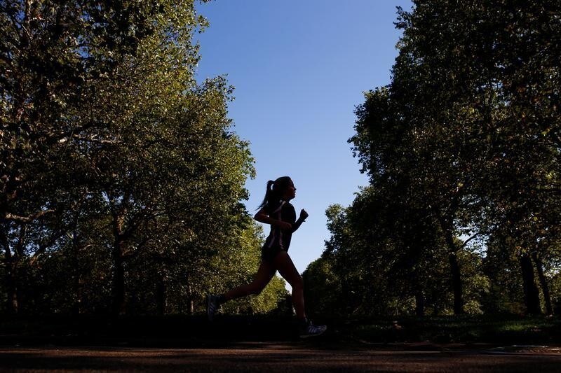 A woman runs through a park in central London, Britain, September 13, 2018. REUTERS/Henry Nicholls - RC1F82D16820