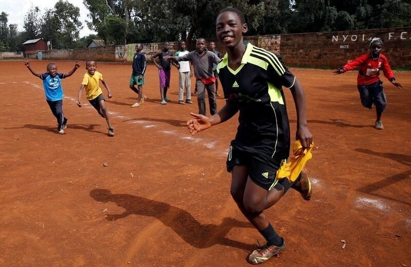 Margaret Atieno celebrates her goal at the Ziwani grounds in Nairobi, Kenya May 27, 2018. "Soccer is my passion and as a girl player I have a bright future in this sport, that is why I play among boys" Atieno said. The eyes of the world will turn to Russia this week for the four-yearly gathering of soccer's superstars but it is away from the glitzy new stadiums built at a staggering cost you must look to find the sport's beating heart; to the dusty streets and poverty-wracked neighbourhoods where the simple act of scoring a goal can still transcend the grind of everyday life.