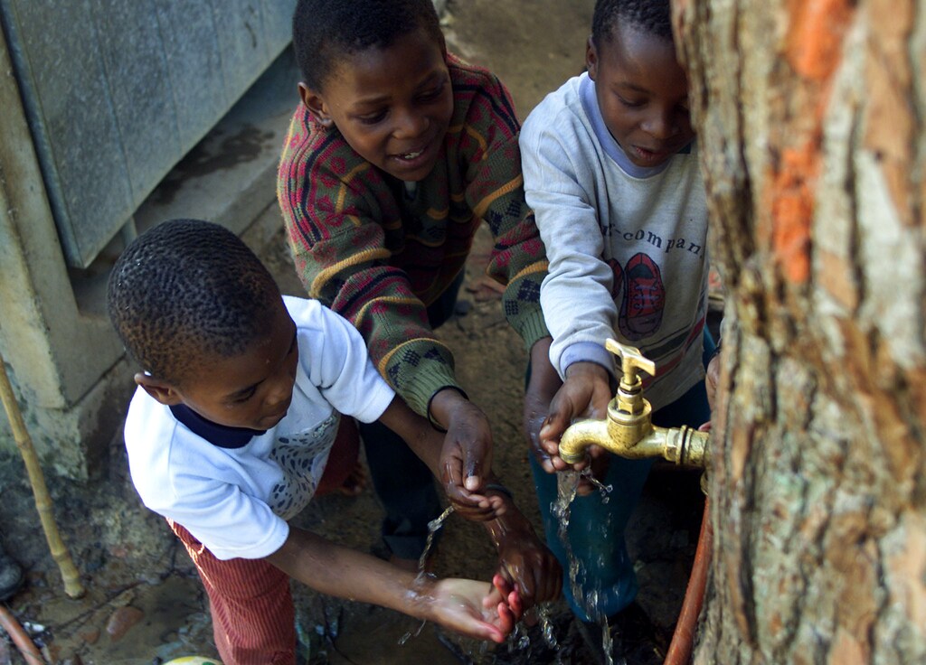 Township children play around a communal tap sevicing the Imizamo Yethucommunity near Cape Town, August 5, 2002. Quenching the planet'sgrowing thirst will be a gigantic task, with some experts warning thatwhole regions are in danger of drying up with catastrophic consequencesfor their impoverished populations. Water was the focus of the EarthSummit on Wednesday, with developing countries pushing for a globaltarget on sanitation to complement the Millennium Development Goal(MDG) of halving the proportion of people without access to cleandrinking water by 2015. FOR RELEASE WITH STORY SUMMIT-ENVIRONMENT-WATERREUTERS/Mike HutchingsMH/CLH/ - RP3DRIDGEZAA