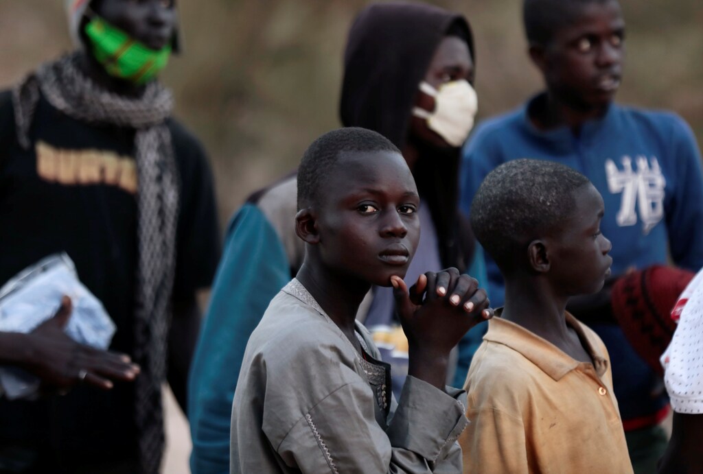 Newly arrived street children receive instructions as they settle at the camp, which the Village Pilot NGO has set up to house and confine children in need of help, amid the spread of the coronavirus disease (COVID-19), in Lac Rose, suburbs of Dakar, Senegal April 20, 2020. Picture taken April 20, 2020. REUTERS/Zohra Bensemra - RC21DG99MFPT