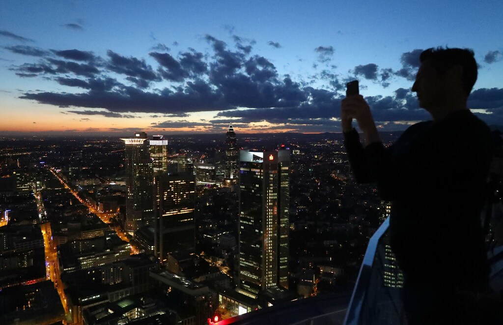 A visitor of a skyscraper observation platform takes a picture of Frankfurt's skyline in Germany, September 29, 2016.