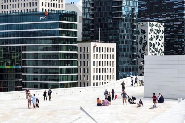 People stand on the roof of the Opera House, with buildings of The Barcode Project in the background, in Oslo, Norway August 05, 2013. Picture taken August 05, 2013. Svein Nordrum/NTB Scanpix/via REUTERS ATTENTION EDITORS - THIS IMAGE WAS PROVIDED BY A THIRD PARTY. FOR EDITORIAL USE ONLY. NORWAY OUT. NO COMMERCIAL OR EDITORIAL SALES IN NORWAY.