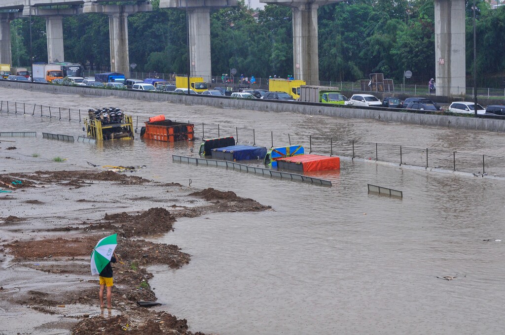 Trucks are seen partially submerged along the Jakarta-Cikampek Toll Road in Bekasi, near Jakarta, Indonesia February 25, 2020.