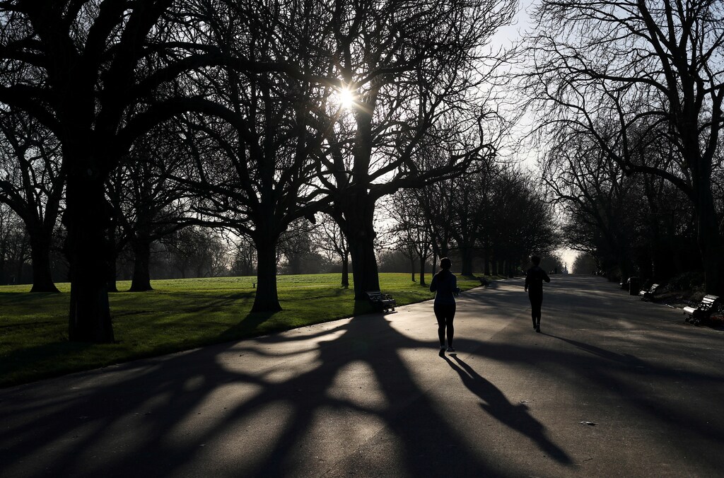 A woman jogs through Regents Park in London, Britain, December 28, 2017. REUTERS/Hannah McKay - RC1219CEBF00