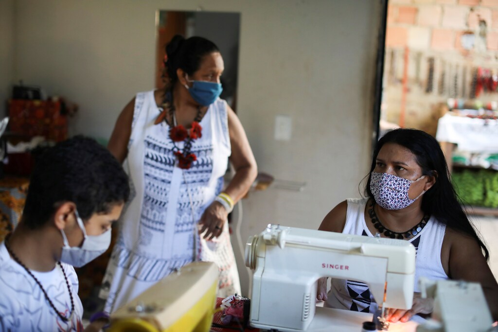 Indigenous women sew face masks for sale during the coronavirus disease (COVID-19) outbreak, at the Satere Mawe Association of Indigenous Women in Manaus, Brazil, April 24, 2020. Picture taken April 24, 2020. REUTERS/Bruno Kelly - RC28DG9UF7Q6