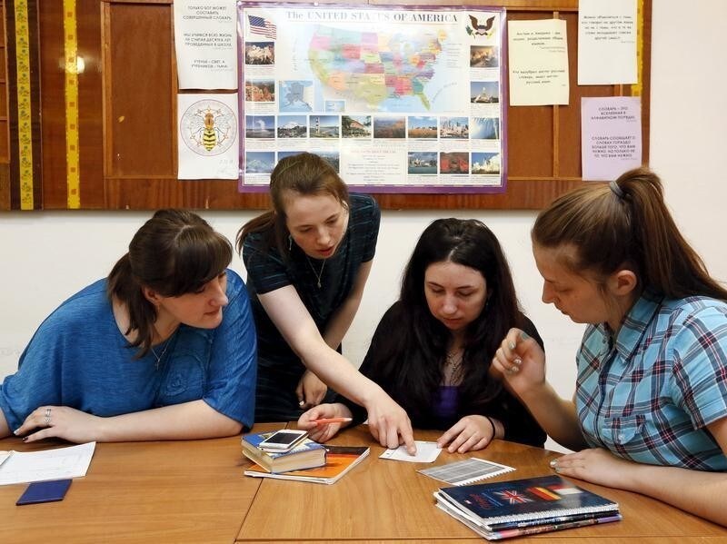 English teacher Laura Thomas (2nd L), who is a British citizen, gives an explanation to students as she conducts a lesson in the town of Lesosibirsk, north of the Russian Siberian city of Krasnoyarsk, April 24, 2015. Thomas, 25, a graduate of the University of Cambridge, developed an interest in the Russian language and culture as a teenager, and left her native town of Congleton, Cheshire in Britain for Lesosibirsk seven months ago to educate Russian trainee teachers in the English language at a local educational institute, a branch of the Siberian Federal University. Thomas has since experienced her first severe Siberian winter and has already made new acquaintances among the local residents. She plans to live and work in the region for at least several years to come. Picture taken April 23, 2015. REUTERS/Ilya Naymushin - GF10000071283