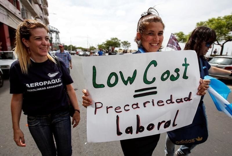 Airline workers protest against the government's plan to operate domestic and international flights in Argentina by low-cost airlines in Buenos Aires, Argentina, December 27, 2016. The sign reads: "Low Cost = Precarious work". REUTERS/Agustin Marcarian - RC12E5A307F0