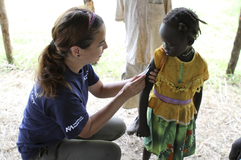 A nurse immunises a young girl for measles at in Gendrassa camp in Maban, Upper Nile State, South Sudan, on the border with Sudan, August 1, 2012. According to the International Medical Corps, an estimated 120,000 refugees have fled violence and hunger in Sudan into camps in South Sudan. Approximately 1,000 refugees were transferred on Wednesday from Jamman camp to the newly constructed Gendrassa camp, where they receive health screenings and vaccinations at International Medical Corps' clinic. International Medical Corps has been providing primary health care, nutrition, water, sanitation and hygiene services in South Sudan since 1994. REUTERS/Margaret Aguirre/International Medical Corps/Handout (SOUTH SUDAN - Tags: SOCIETY POLITICS CIVIL UNREST HEALTH) - RTR35U6P