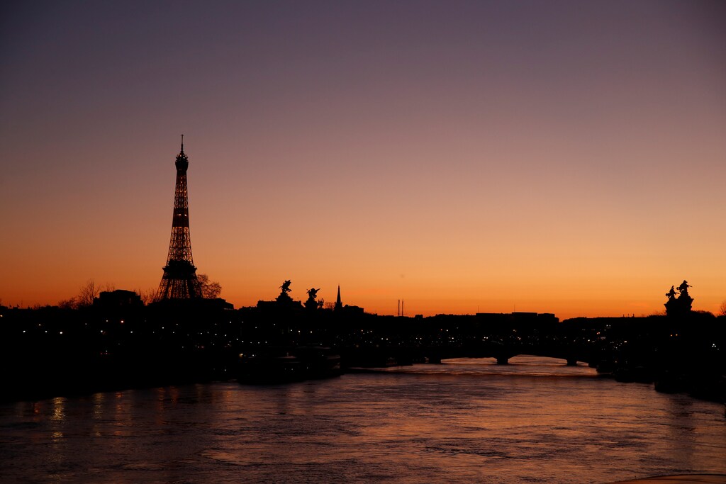 The Eiffel Tower is seen at sunset in Paris as a lockdown is imposed to slow the rate of the coronavirus disease (COVID-19) spread in France, March 24, 2020. REUTERS/Gonzalo Fuentes - RC2JQF99AL09