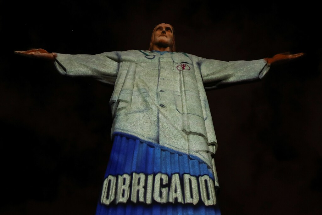 La estatua del Cristo Redentor está iluminada con una imagen del atuendo de un personal sanitario y la palabra "gracias" durante los eventos del Domingo de Pascua, en medio del brote de la enfermedad coronavirus (COVID-19), en Río de Janeiro, Brasil, el 12 de abril de 2020.